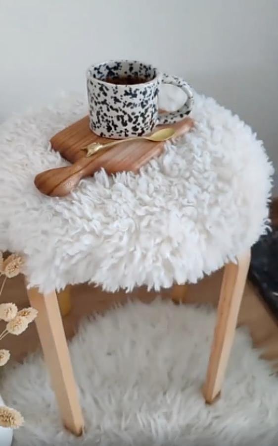 El taburete Kyrre (11 euros) de IKEA es bastante simple, pero si le añades una tela de borreguillo blanco, queda como si lo hubieras comprado en una sofisticada tienda de decoración.