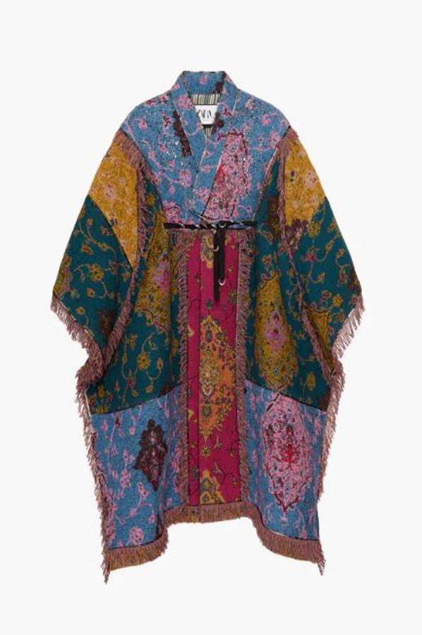 Poncho en patchwork con tres estampados jacquard de entramados diferentes. El tejido muestra un acabado con un ligero efecto acolchado. Las costuras del patchwork están resaltadas con jacquard metálico. Tiene acabados desflecados en mismo tejido y las costuras interiores muestran acabados de rayas y ribetes de viscosa negra (299 euros).