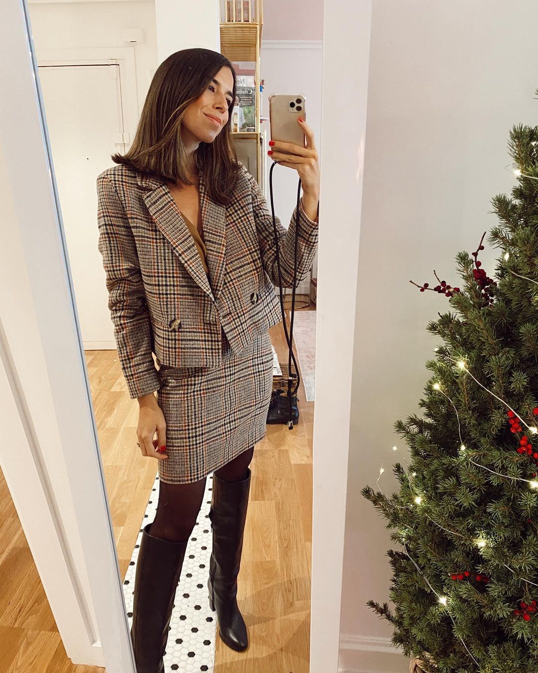 Si buscas un look working girl perfecto, aquí tienes una buena inspiración: este conjunto de tweed de Bimani con chaqueta cropped y mini falda con estampado de cuadros es ideal. Y nos encanta el toque setentero que dan las botas altas de tacón cómodo.