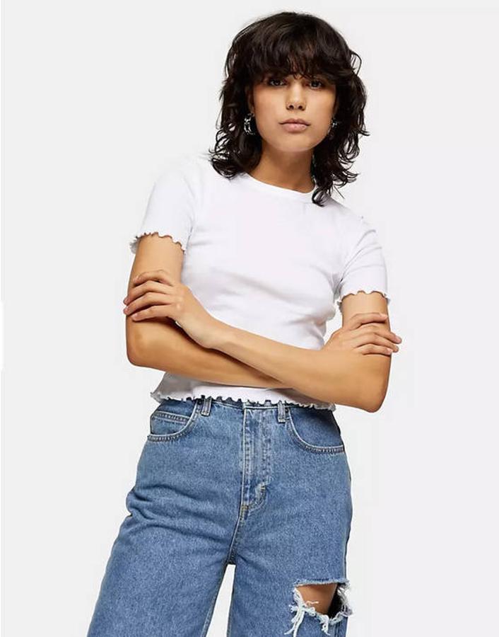 Otra buena opción es un diseño en color blanco con ribete ondulado de Topshop. Tiene el cuello redondo y la manga corta. Puedes comprarlo en Asos por 7,99 euros.
