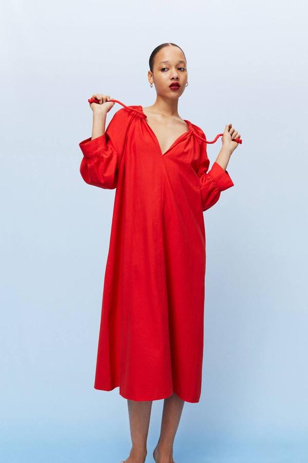Vestido midi en tejido de algodón vaporoso, con cuello redondo decorado con cordones, escote de pico, manga abombada tres cuartos y corte amplio, de H&M. Cuesta 34,99 euros.