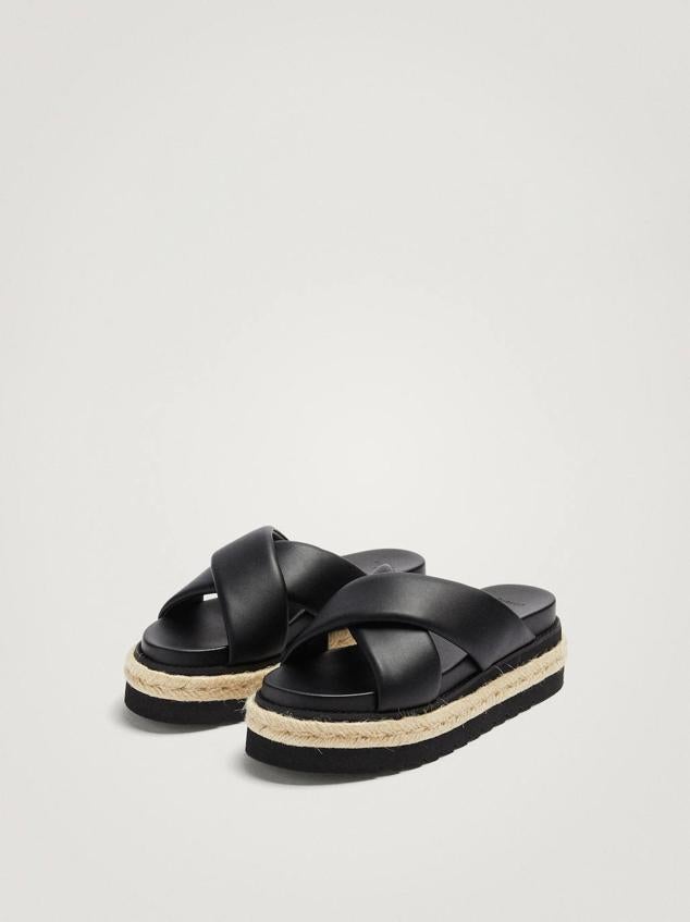 Sandalia destalonada con tejido combinado, suela plana con plataforma y tiras cruzadas acolchadas, color negro. Está rebajada a 25,99 euros.