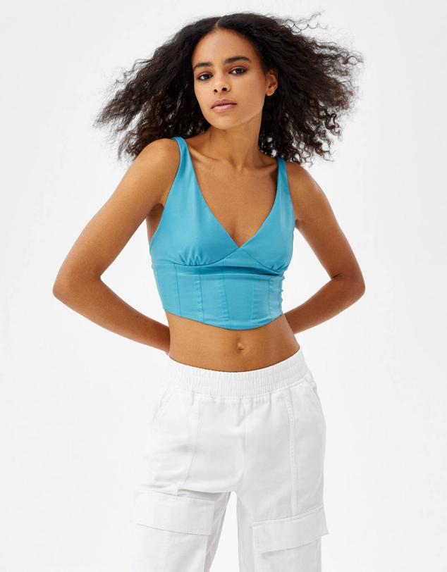 Top corsé en tejido efecto piel con tirantes, escote de pico y copas marcadas, de Bershka. Puedes encontrarlo rebajado por 7,99 euros, en turquesa, rosa o negro. Cómpralo aquí