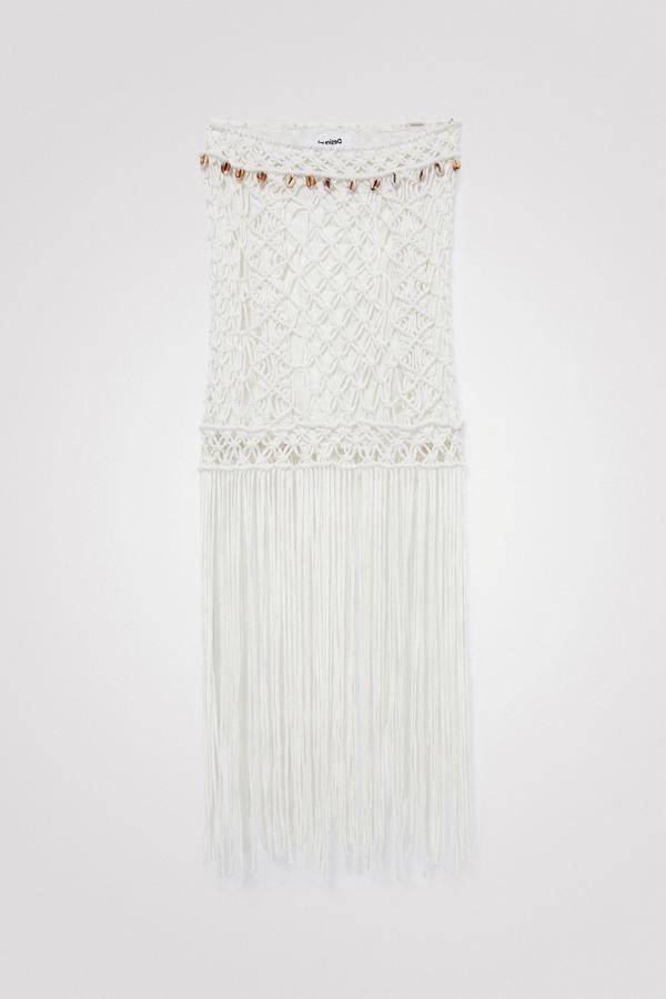 Macramé de galga amplia y largos flecos en esta minifalda blanca con forro interior. También tiene conchas decorativas en la cinturilla para poder llevar un look muy veraniego. Es de Desigual. Precio rebajado: 90,96 €.