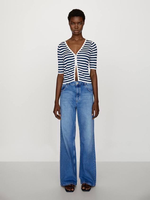 Cárdigan en tejido de punto fino con escote de pico, silueta acomodada al cuerpo, cierre de botones y manga corta, en estampado a rayas azul y blanco, de Massimo Dutti. Cuesta 39,95 euros.