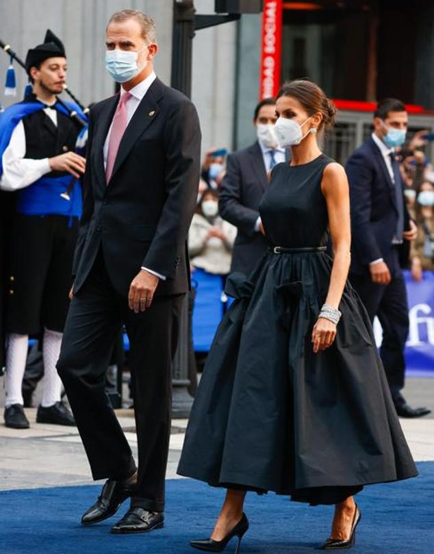 Doña Letizia sacó su mejor versión en los Premios Princesa de Asturias 2021 y brilló como nunca con un imponente diseño de inspiración 'new look' de la firma española The 2nd Skin&Co al que nadie ha podido hacer sombra. Un vestido negro de tafetán, con cuello a la caja sin manga y falda midi con volumen rematada con lazos, que era una auténtica maravilla.