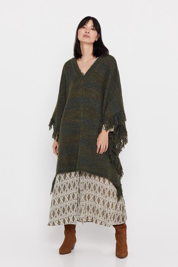 Poncho largo desflecado por la zona de los costados y con escote en V. Es de Cortefiel. Precio: 89,99 €.  Cómpralo aquí