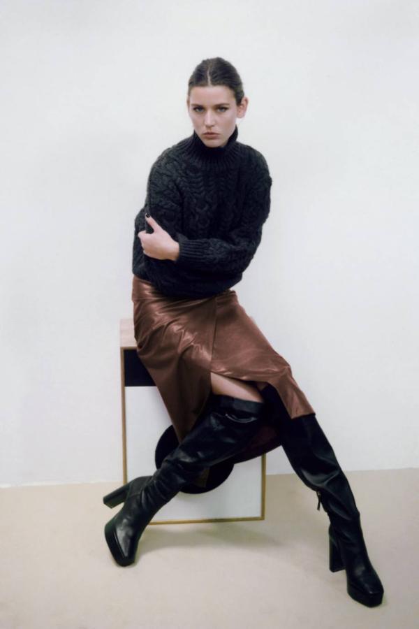 Falda midi en tejido efecto piel con diseño cruzado con detalle de nudo, tiro alto, silueta entallada y abertura, color marrón oscuro, de Zara. La encontrarás a 29,95 euros.