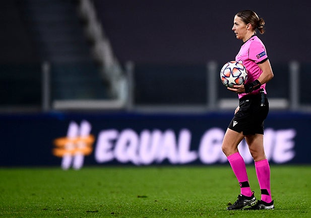 ALLIANZ STADIUM, TURIN, ITALY - 2020/12/02: Referee Stephanie Frappart holds the ball in front of a billboard reading 'equal game' at the end of the UEFA Champions League Group G football match between Juventus FC and FC Dynamo Kyiv. French referee Stephanie Frappart becomes the first-ever female official to referee a men's Champions League game. Juventus FC won 3-0 over Dynamo Kyiv. (Photo by Nicolò Campo/LightRocket via Getty Images)