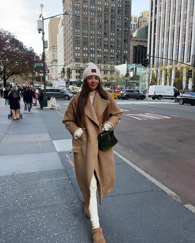 Aretha ha optado por el total white con unas mallas y jersey y ha completado el look con un abrigo camel a juego con las botas.