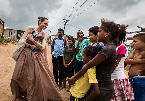RIOHACHA, COLOMBIA - JUNE 07: (EDITORIAL USE ONLY) In this handout image provided by United Nations High Commission for Refugees, UNHCR Special Envoy Angelina Jolie speaks with children in Riohacha, Colombia, on June 7, 2019. Jolie visited the children, who had fled Venezuela, in Brisas del Norte, an informal settlement inhabited by Colombian refugees who have returned to their country as well as Venezuelans escaping a political and economic crisis back home. Over 4 million Venezuelans are now living in exile, with Colombia taking in the greatest share, even as it seeks to implement a peace deal ending five decades of conflict inside its own borders.  (Photo by Andrew McConnell / UNHCR via Getty Images)