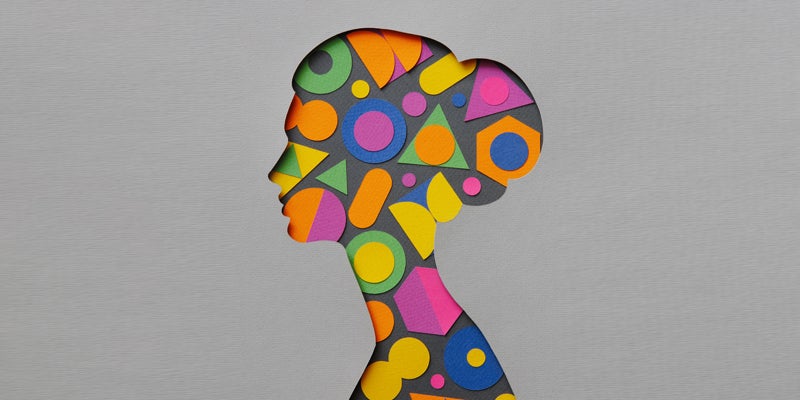 Paper craft illustration of a young woman filled with multi colored geometric shapes