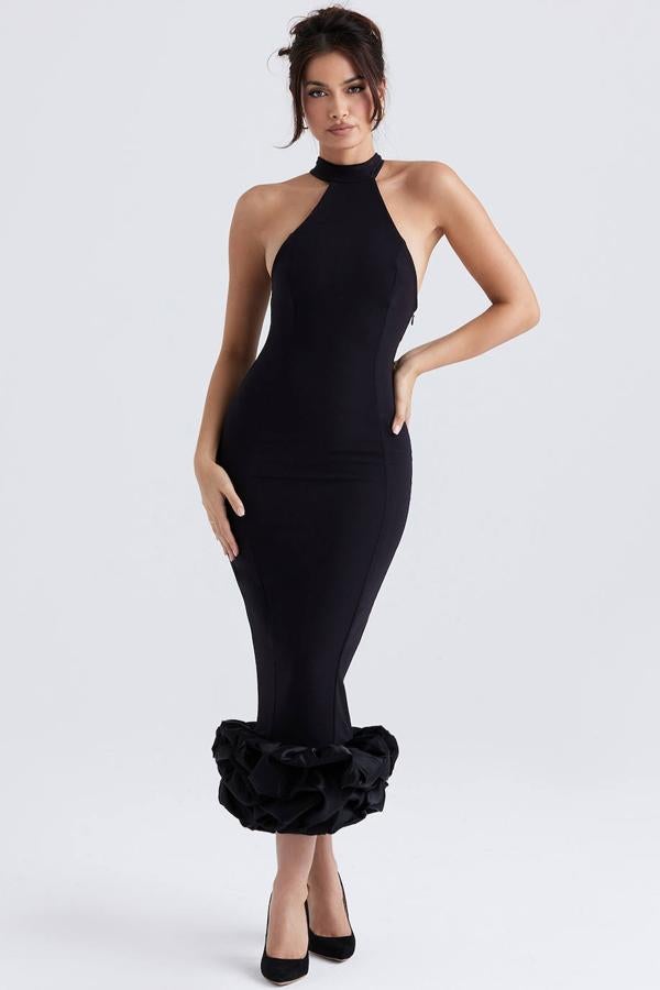 Vestido largo entallado con cuello halter y bajo con peplum, color negro. Cuesta 235 euros.