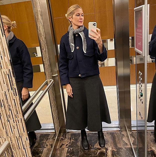 Kelly Rutherford con look con botas y falda midi