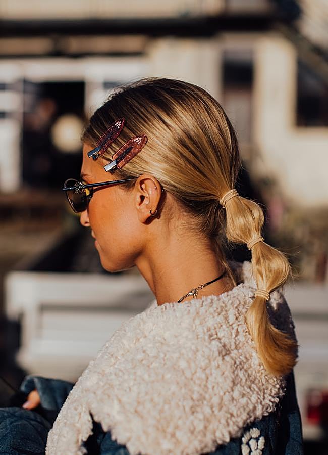 Imagen - Una mujer con coleta bubble ponytail y horquillas.