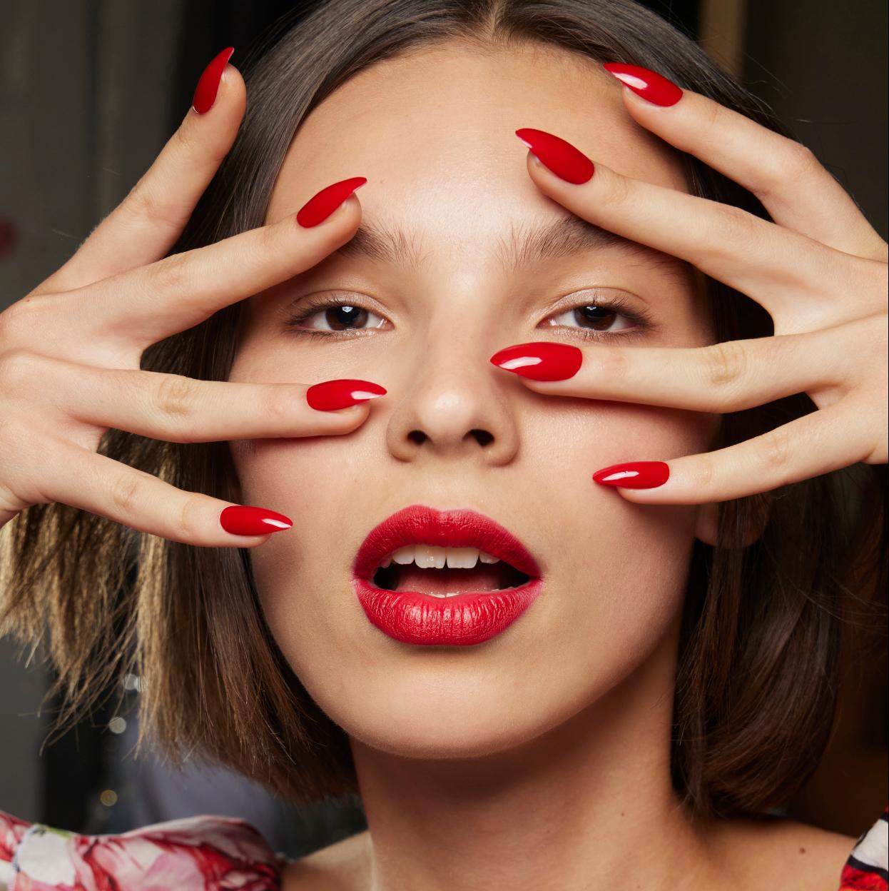 Una modelo con una manicura roja.
