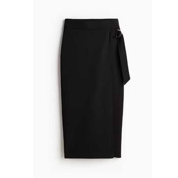 Imagen secundaria 1 - Jersey de punto con costuras en contraste de NA-KD (27,47€)/ Falda cruzada de punto de H&M (15,99€)/ Bota alta 100% piel de Mango (169,99€)