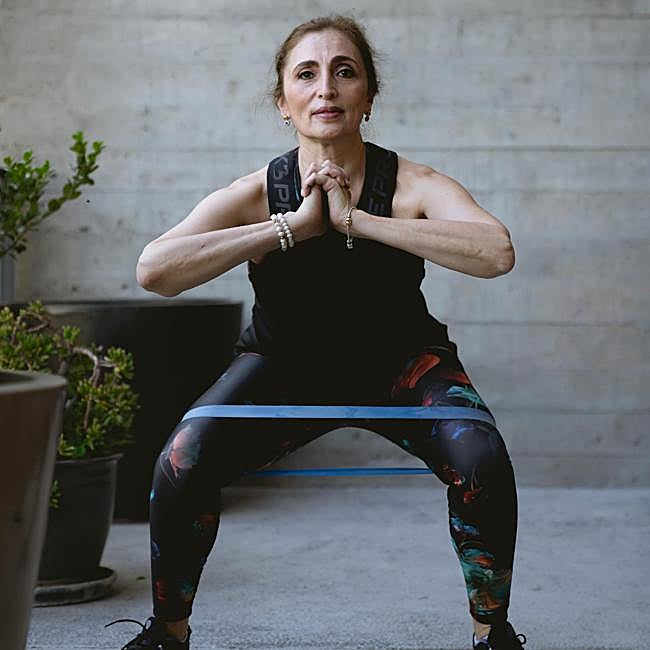 Mujer haciendo ejercicio con una banda elástica.