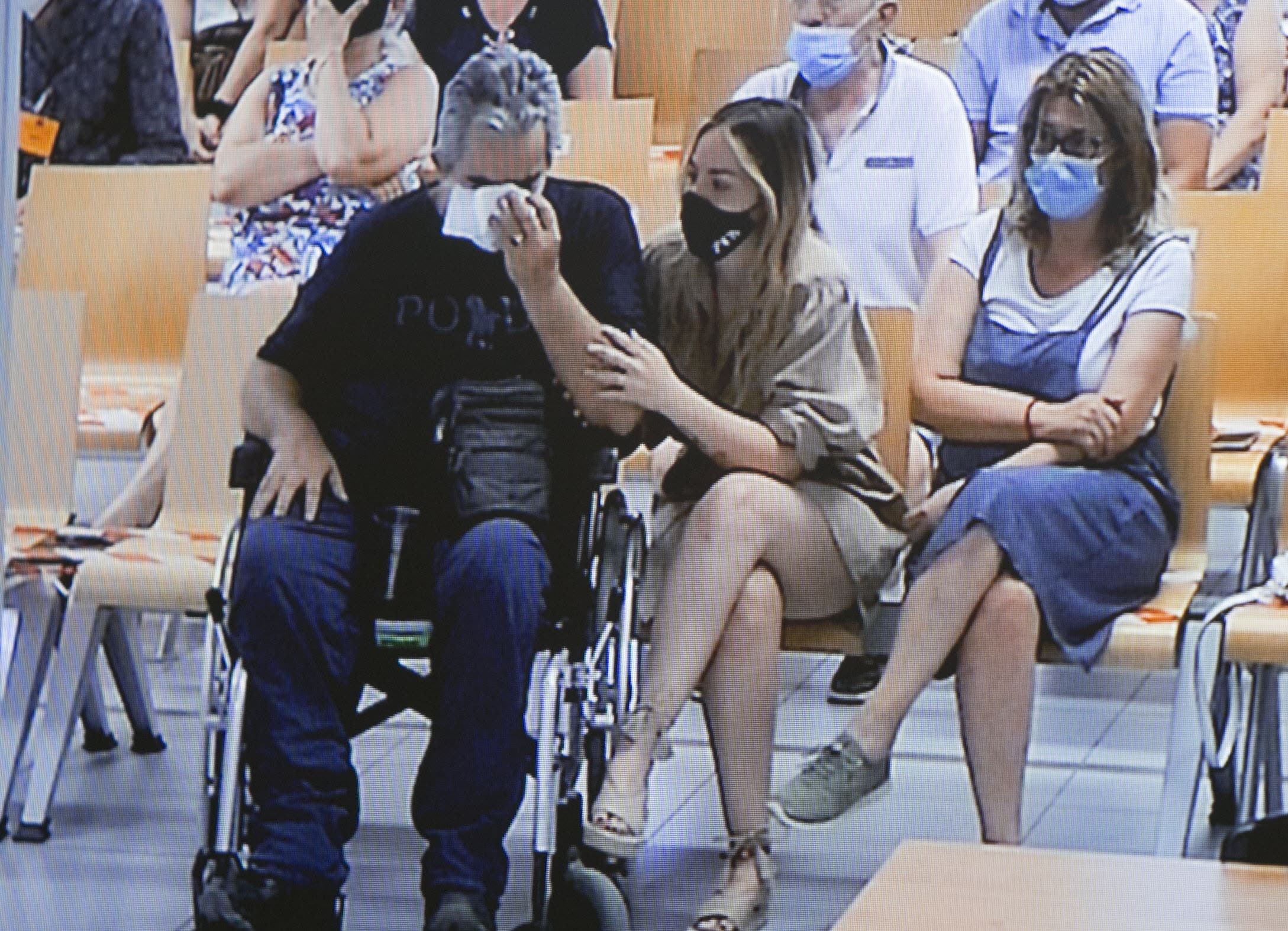 Alba Ferrer comforts her father, at a time of the trial