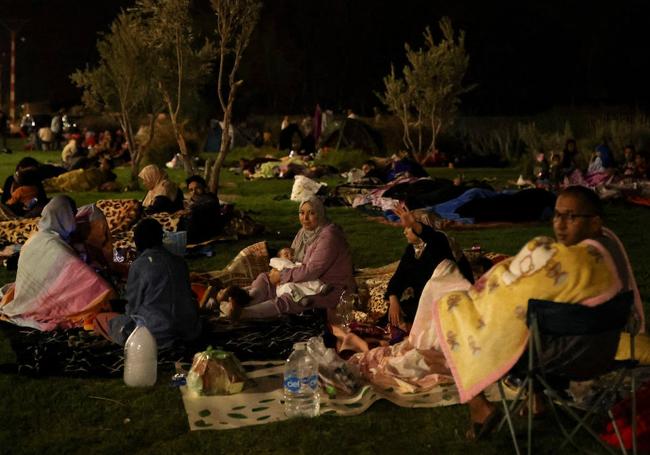 Los residentes descansan a lo largo de la Avenida de la Menara después de que el terremoto destruyera sus casas