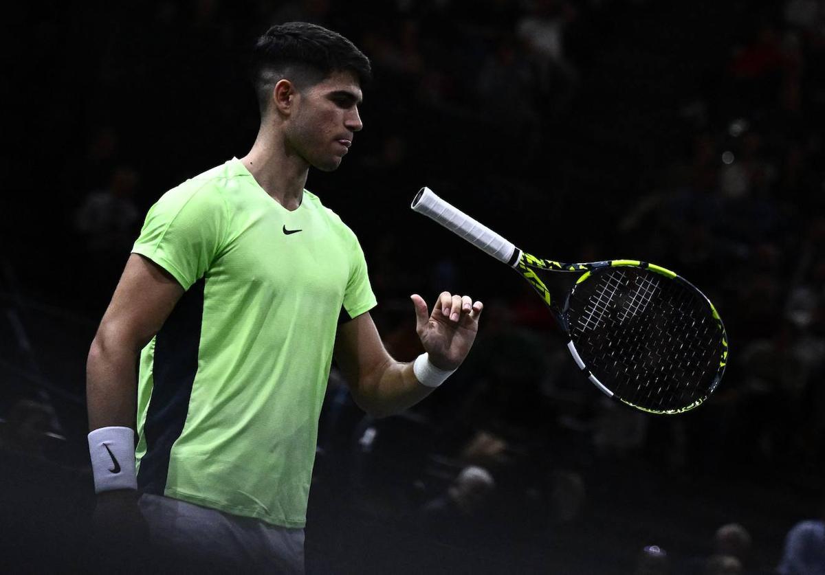 Carlos Alcaraz suelta su raqueta, frustrado tras su derrota este martes ante el tenista ruso Roman Safiullin en París.