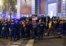 Los policías tratan de que los manifestantes contra la amnistía no salgan de la acera cerca de la madrileña calle Ferraz y puedan cortar el tráfico.