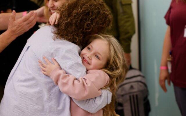 Little Emilia hugs her grandmother.