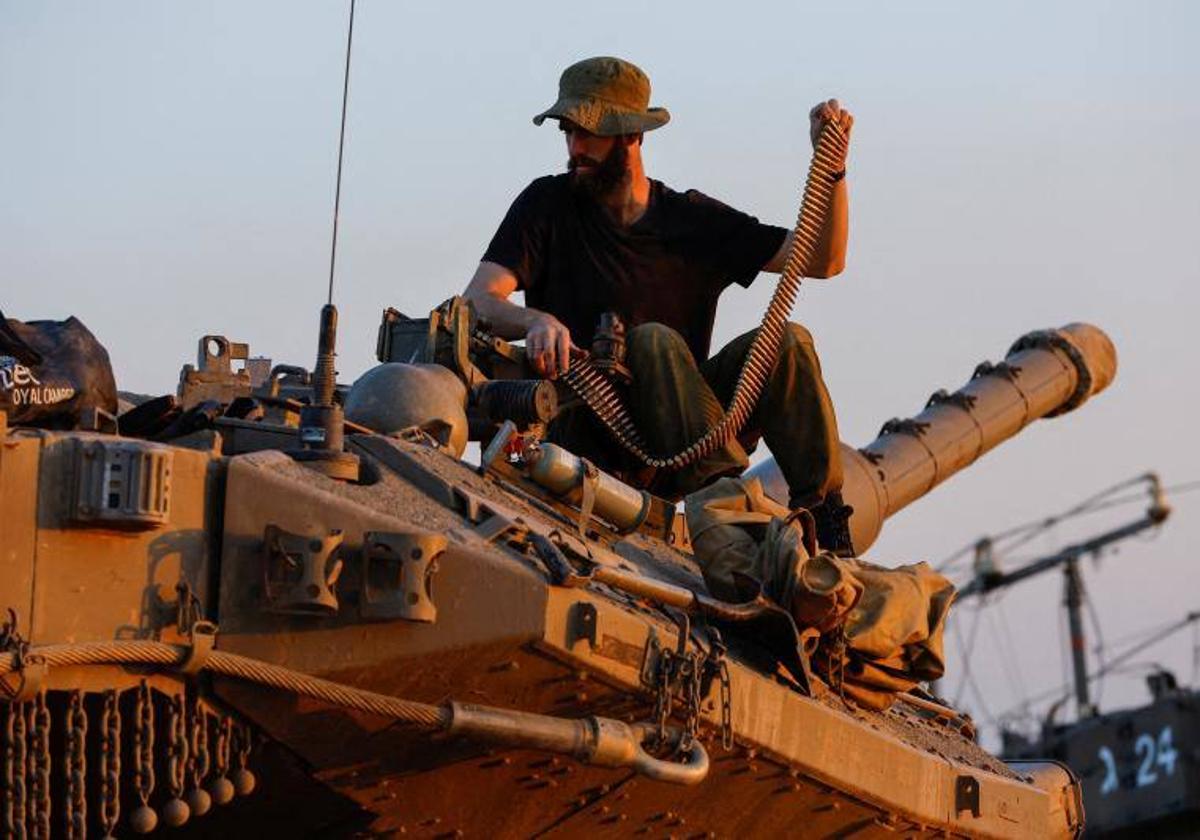 Un soldado israelí prepara la ametralladora encima de un tanque.