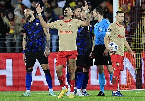 Celebración de los jugadores del Lens y lamento sevillista tras la jugada del penalti a favor del conjunto francés.