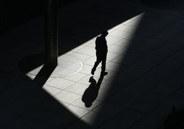 Un joven camina solo por una calle.