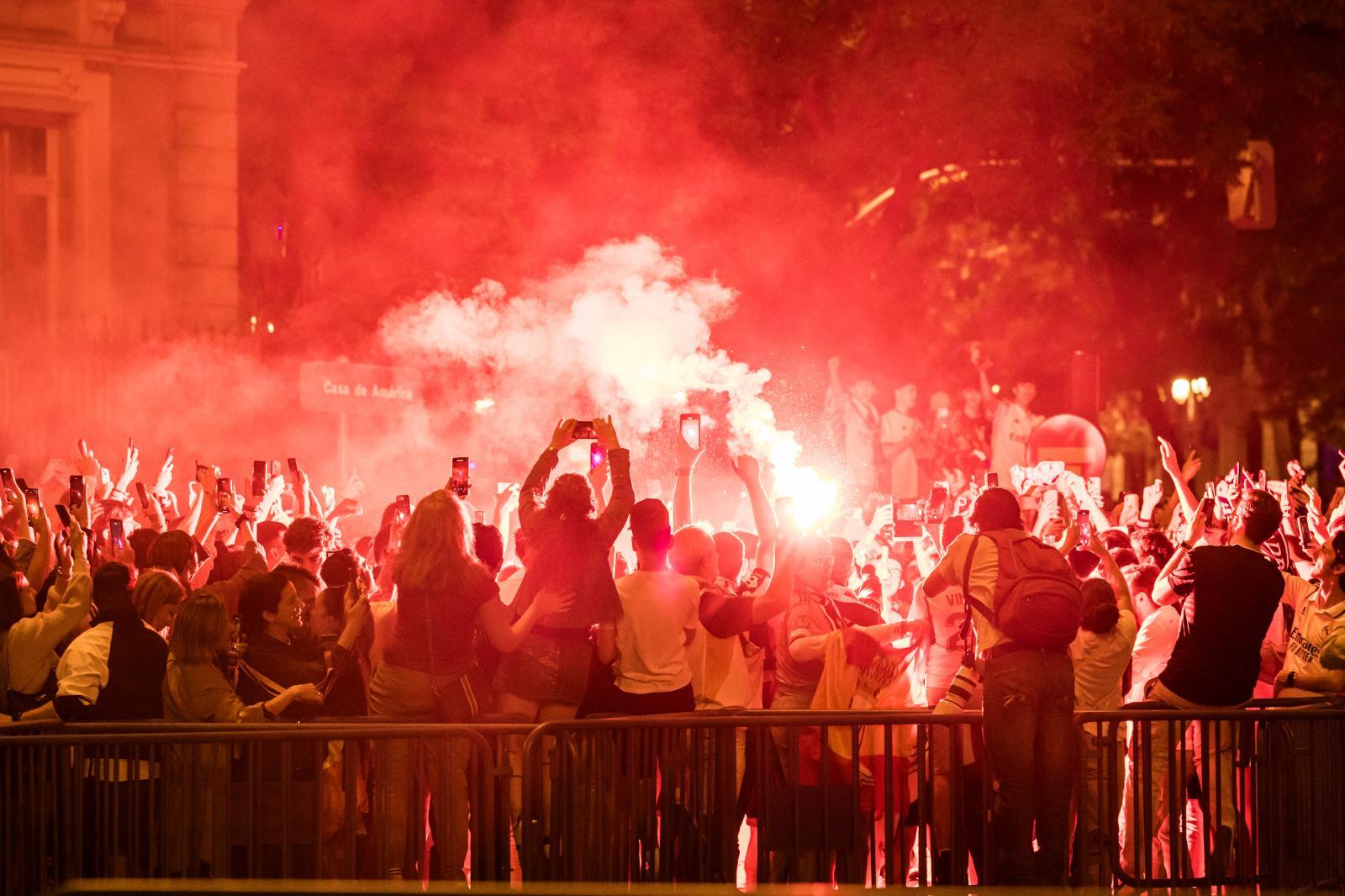 Unos aficonados prenden en el entorno de Cibeles vengalas para celebrar la victoria.