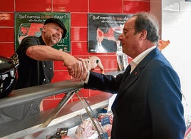 François Hollande, expresidente socialista francés, hace campaña en un mercado.