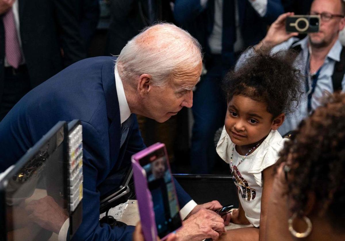 Biden se dirige a una niña durante una visita a un mercado de Las Vegas.