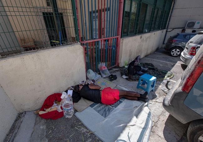 Dos inmigrantes durmiendo junto al CETI de Ceuta.