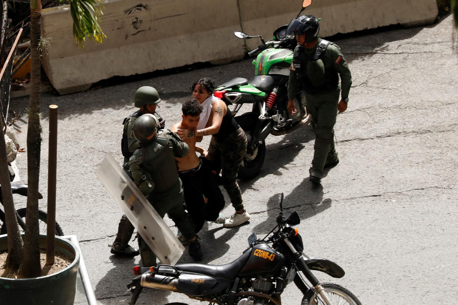 The National Guard arrests a young protester critical of the Chavista victory.