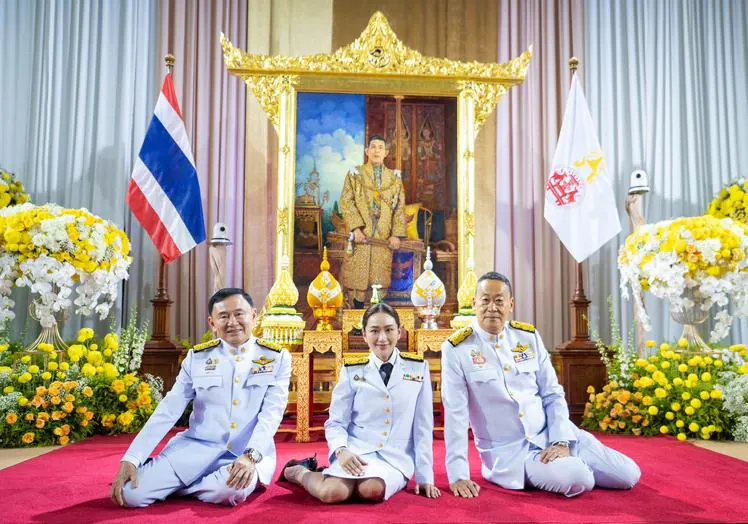 Thaksin Shinawatra (left) and his daughter, center, Thailand's new prime minister.