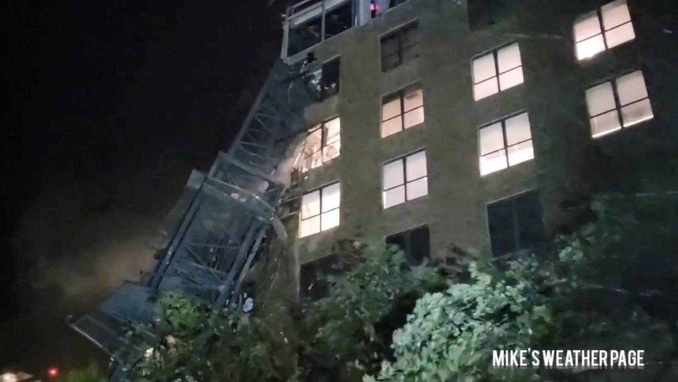 Una grúa se derrumba sobre un edificio, durante las fuertes lluvias y fuertes vientos causados ​​por el huracán Milton, en San Petersburgo, Florida.