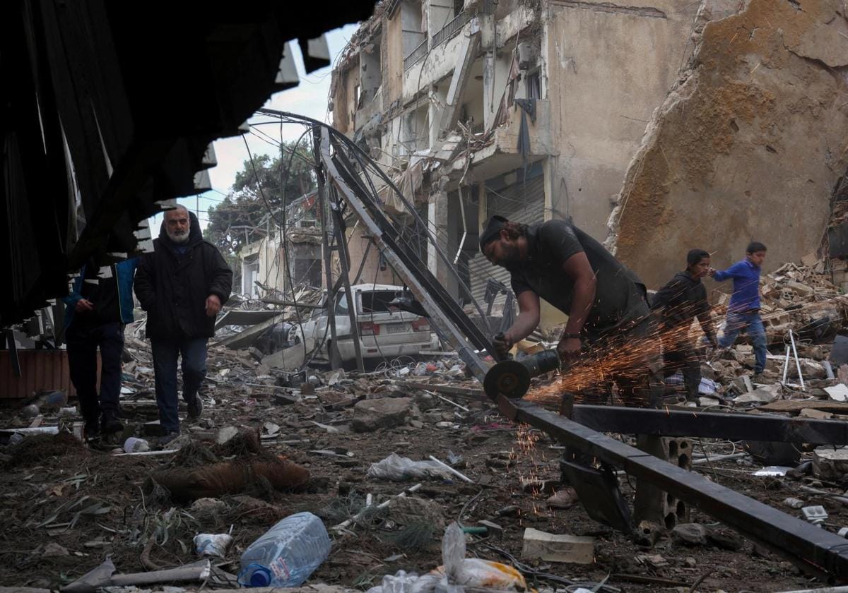 Un hombre realiza labores de reconstrucción en un barrio de Beirut arrasado por los bombardeos israelíes.