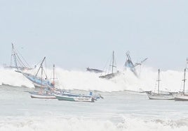 Fuertes olas golpean varias embarcaciones en la localidad costera de El Ñuro, en el norte de Perú.