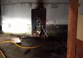 Un bombero en la puerta de la vivienda afectada por el fuego en el que ha muerto un niño de 10 años y una mujer de 75.