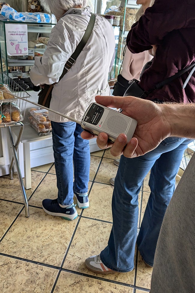 Una mujer escucha una radio inalámbrica para conocer los últimos detalles sobre el apagón