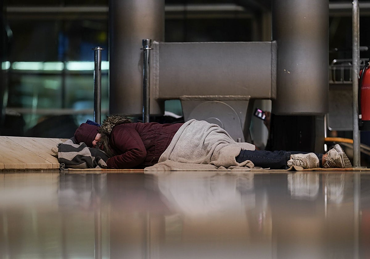 Un hombre pernocta en la T4 de Barajas.