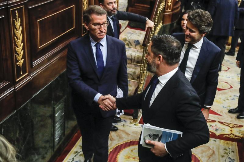 El líder del PP, Alberto Núñez Feijóo, estrecha la mano al de Vox, Santiago Abascal