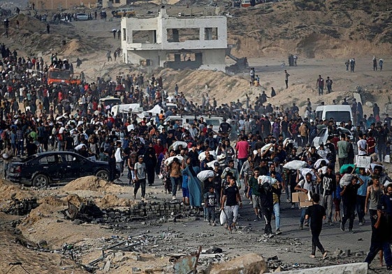 Decenas de personas esperan para recoger comida en Beit Lahia.