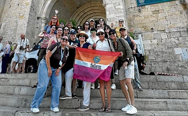 Participantes en un viaje organizado por Bolleras Viajeras posan a las puertas de una iglesia en Lisboa.