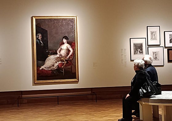 Dos visitantes observan la obra 'La marquesa de Villafranca pintando a su marido'.