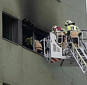 Bomberos entran en el edificio incendiado.