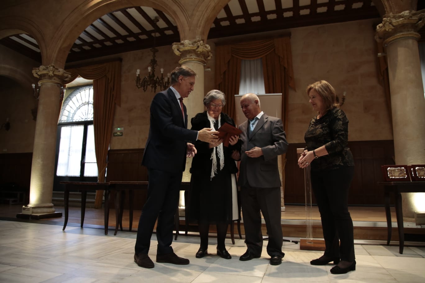 El alcalde de Salamanca entrega una placa a un matrimonio. 