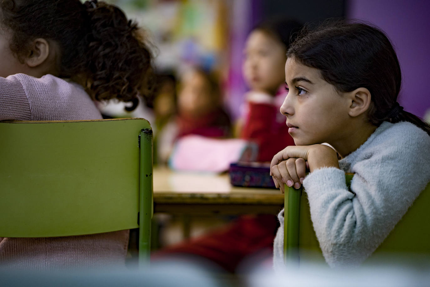 Niñas atendiendo a clase en el aula de un colegio.
