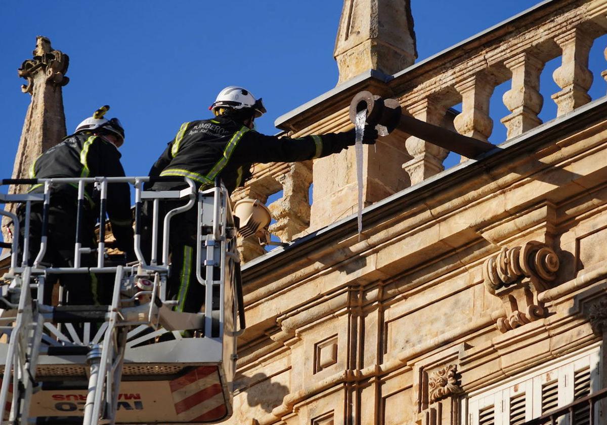Dos bomberos se disponen a realizar una intervención en la Plaza Mayor de Salamanca.